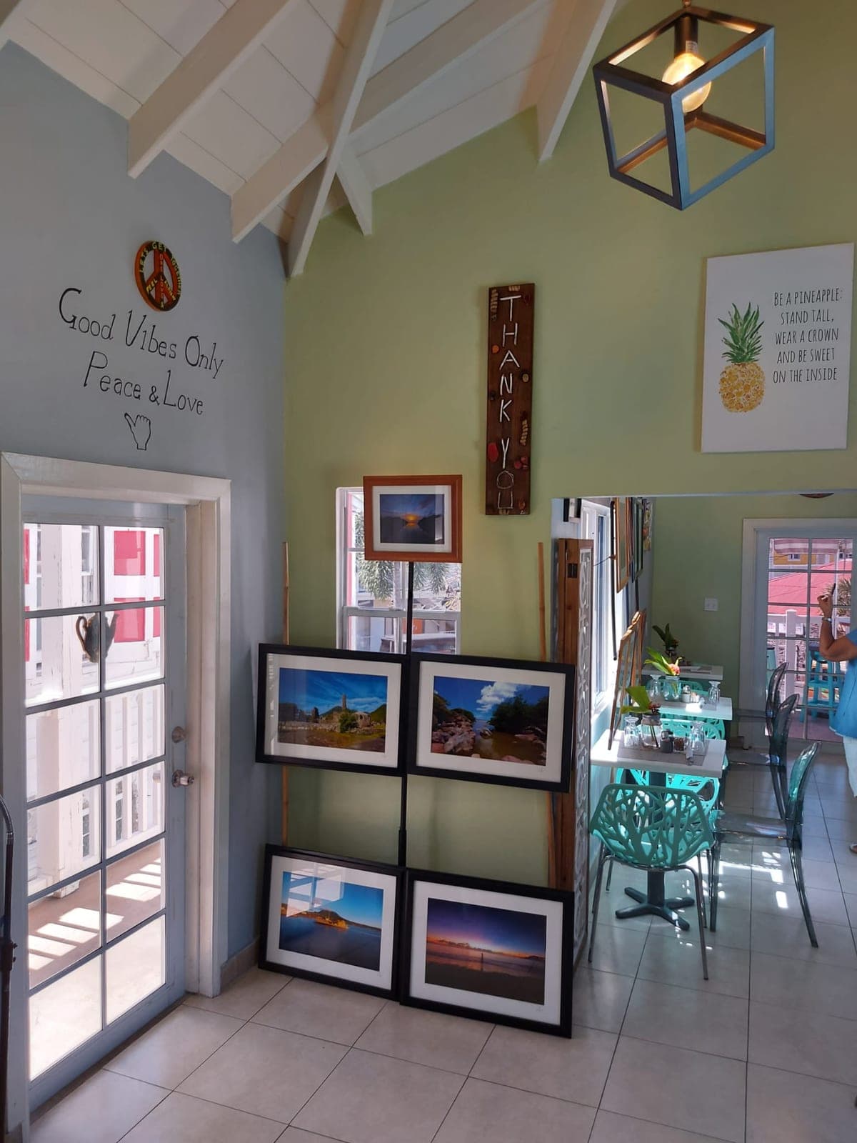 Three visitors standing and talking among the framed prints during the art show
